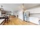 Open floorplan connecting the kitchen, dining, and living areas with hardwood floors and stainless appliances at 12201 N Holly Way, Brighton, CO 80602