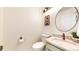 Well-lit powder room featuring decorative mirror and decor at 12201 N Holly Way, Brighton, CO 80602