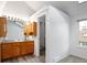 Bathroom vanity with wood cabinetry, a modern sink, and a walk-in closet for storage at 2082 S Helena St # C, Aurora, CO 80013