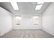 Spacious bedroom featuring skylights, a ceiling fan, and natural light with ample closet space at 2082 S Helena St # C, Aurora, CO 80013