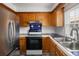 Kitchen featuring stainless steel refrigerator, dark countertops and wood cabinets at 2082 S Helena St # C, Aurora, CO 80013