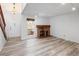 Open living area featuring a classic brick fireplace and wood-look flooring at 2082 S Helena St # C, Aurora, CO 80013