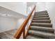 Carpeted staircase with wood handrail leads to the upper floor at 2082 S Helena St # C, Aurora, CO 80013