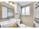 Bright bathroom featuring a modern sink, toilet, shower with curtain and large mirror at 33 Corona St # 207, Denver, CO 80218