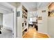 Hallway featuring hardwood floors, storage shelving, and views of the living room at 33 Corona St # 207, Denver, CO 80218