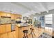 Bright kitchen with stainless appliances, mosaic backsplash, island, and hardwood floors at 33 Corona St # 207, Denver, CO 80218