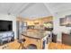 Modern kitchen with stainless steel appliances, island, and hardwood floors at 33 Corona St, Denver, CO 80218