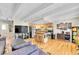 Open living room featuring a modern kitchen with stainless appliances and hardwood floors at 33 Corona St # 207, Denver, CO 80218