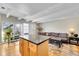 Inviting living room featuring an island, modern lighting, and hardwood floors at 33 Corona St # 207, Denver, CO 80218