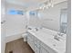 Bathroom featuring double sinks and vanity, a large mirror, and white cabinets at 9515 Bexley Dr, Highlands Ranch, CO 80126