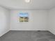 A simple, empty bedroom with carpeted floors and great natural light through the large windows at 9515 Bexley Dr, Highlands Ranch, CO 80126