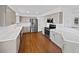 Modern kitchen featuring stainless steel appliances, stone countertops, and hardwood floors at 9515 Bexley Dr, Highlands Ranch, CO 80126