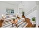 Bright living room with white walls, hardwood floors, and a large window providing natural light at 9515 Bexley Dr, Highlands Ranch, CO 80126