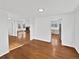 Spacious open-concept living room with hardwood floors and seamless flow into the kitchen and fireplace at 9515 Bexley Dr, Highlands Ranch, CO 80126