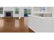 Bright open concept living room and kitchen with pristine white walls at 9515 Bexley Dr, Highlands Ranch, CO 80126
