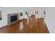 Inviting living room with hardwood floors and a classic brick fireplace at 9515 Bexley Dr, Highlands Ranch, CO 80126