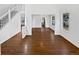 Bright and spacious living area featuring hardwood floors, white walls, staircase, and abundant natural light at 9515 Bexley Dr, Highlands Ranch, CO 80126