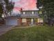 Brick home with a two-car garage and front yard lighting at 824 S Nelson Way, Lakewood, CO 80226
