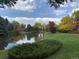 Scenic view of a serene pond surrounded by lush greenery and colorful trees at 847 Racquet Ln, Boulder, CO 80303