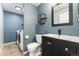 Modern bathroom with dark vanity and laundry area at 10890 W Belmont Ave, Littleton, CO 80127