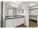 Double vanity bathroom with large mirror and walk-in closet at 10890 W Belmont Ave, Littleton, CO 80127