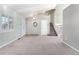 Bright and airy entryway with neutral-toned carpeting and staircase at 10890 W Belmont Ave, Littleton, CO 80127