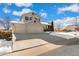 Two-story house with a three-car garage and snow-covered landscaping at 10890 W Belmont Ave, Littleton, CO 80127