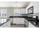 Modern kitchen with stainless steel appliances and granite countertops at 10890 W Belmont Ave, Littleton, CO 80127