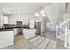 Modern kitchen with white cabinets, granite countertops, and an island at 10890 W Belmont Ave, Littleton, CO 80127