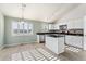 Modern kitchen with white cabinets, granite countertops, and an island at 10890 W Belmont Ave, Littleton, CO 80127