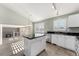 Modern kitchen with white cabinets, granite countertops, and an island at 10890 W Belmont Ave, Littleton, CO 80127