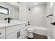 Bathroom showcases sleek white vanity, black fixtures, and modern shower/tub combo at 1563 N Hooker St, Denver, CO 80204