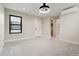 Bedroom with modern light fixture, large window and en-suite bathroom at 1563 N Hooker St, Denver, CO 80204