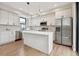Bright kitchen featuring white cabinets, stainless appliances, and a kitchen island at 1563 N Hooker St, Denver, CO 80204