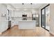 Bright kitchen featuring white cabinets, stainless appliances, and a kitchen island at 1563 N Hooker St, Denver, CO 80204