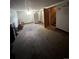 Spacious carpeted basement leading to staircase and storage, including a refrigerator at 1255 Yates St, Denver, CO 80204