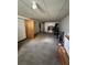 Unfinished basement featuring carpeted flooring and access to additional storage space at 1255 Yates St, Denver, CO 80204