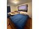 A spacious bedroom features two beds, wood floors, and a ceiling light, enhancing the cozy ambiance at 1255 Yates St, Denver, CO 80204