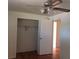 A view of a bright bedroom with a ceiling fan and closet with open doors, and hardwood floors at 1255 Yates St, Denver, CO 80204