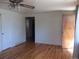 Bright living room with hardwood floors, featuring a ceiling fan and neutral walls at 1255 Yates St, Denver, CO 80204