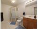 Basement bathroom with shower, toilet and wood vanity at 15602 E Dorado Pl, Centennial, CO 80015