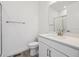 Clean bathroom with glass-enclosed shower, modern fixtures, and white vanity at 8630 Pennycress Dr, Littleton, CO 80125