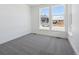 Bright bedroom with neutral carpet and two large windows overlooking the neighborhood at 8630 Pennycress Dr, Littleton, CO 80125