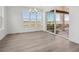 Bright dining area featuring wood-look floors, modern light fixture, and sliding glass doors at 8630 Pennycress Dr, Littleton, CO 80125