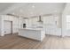 Modern kitchen with stainless steel appliances, large center island, and white cabinets at 8630 Pennycress Dr, Littleton, CO 80125