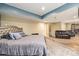 Comfortable basement bedroom featuring a queen sized bed, a sofa, and neutral carpeting at 2835 S Jebel Way, Aurora, CO 80013