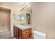 Bathroom featuring double sinks, a large mirror, and a neutral color scheme at 2835 S Jebel Way, Aurora, CO 80013