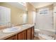 Bathroom featuring double sinks, a large mirror, and a tub with a shower at 2835 S Jebel Way, Aurora, CO 80013
