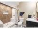 Modern bathroom with a marble-walled shower, toilet, and dark vanity with marble countertop at 2835 S Jebel Way, Aurora, CO 80013