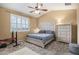 Bedroom featuring neutral walls, a ceiling fan, and a bed with matching furniture at 2835 S Jebel Way, Aurora, CO 80013